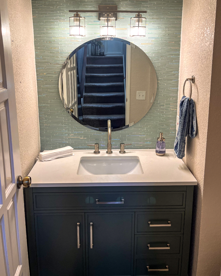 Powder Room Remodel San Diego with Round Mirror and Green Vanity Design
