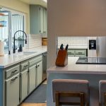 Sage green cabinets and sink area opening to a counter with bar stools in a remodeled College Area kitchen